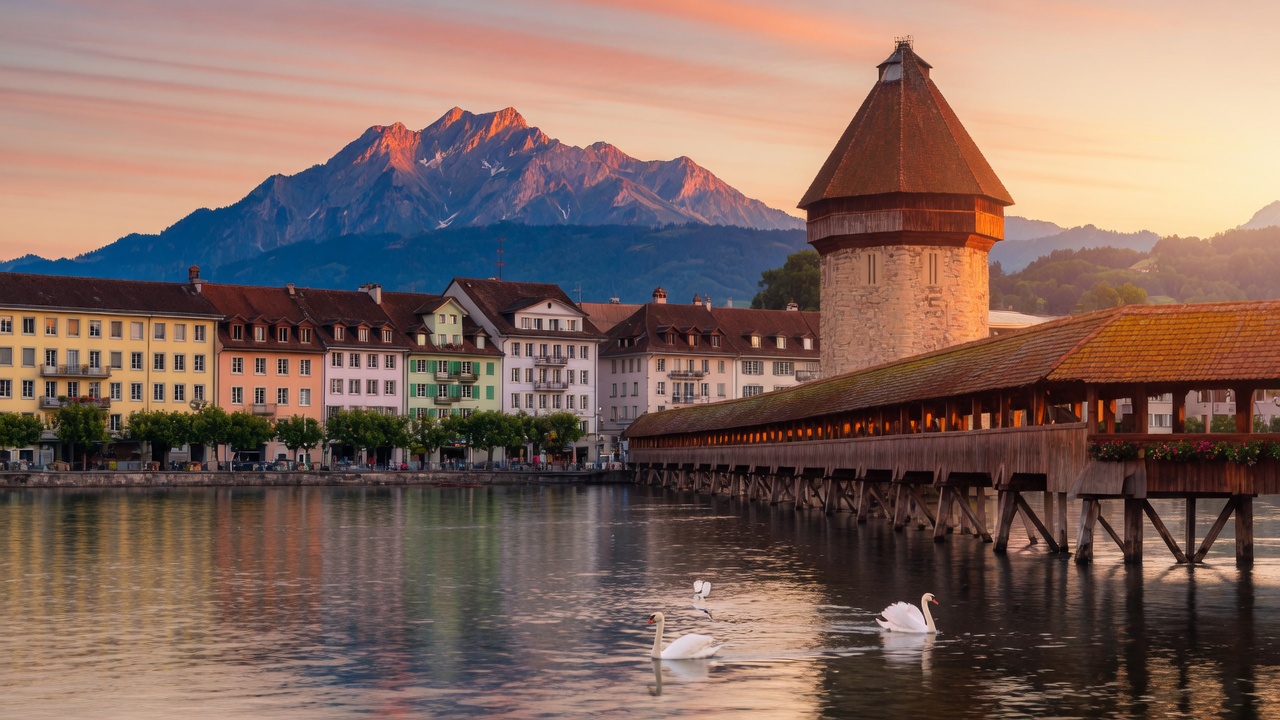 Lucerne Chapel Bridge and water tower at sunset with Pilatus behind